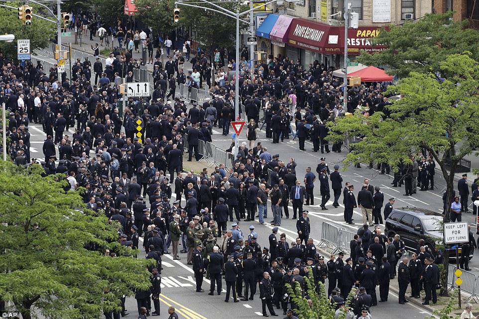 Police congregated on the Grand Concourse after the funeral to line the pathway for the hearse carrying Familia's coffin 