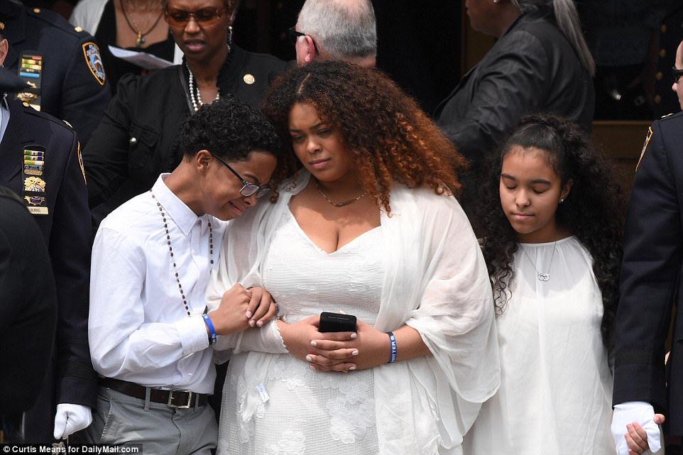 The siblings led thousands of mourners out of the church immediately after the service on Tuesday morning 