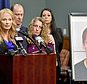 FILE - In this May 5, 2017, file photo, Centre County, Pa., District Attorney Stacy Parks Miller, left, announces the findings of an investigation into the death of Penn State University fraternity pledge Tim Piazza, seen in photo at right, as his parents, Jim and Evelyn Piazza, second and third from left, stand nearby during a news conference in Bellefonte, Pa. A preliminary hearing is set to resume Thursday, Aug. 10 for members of Penn State University's now-shuttered Beta Theta Pi fraternity chapter, accused in the Feb. 4 death of 19-year-old Tim Piazza, of Lebanon, N.J., after a night of heavy drinking. (Abby Drey /Centre Daily Times via AP, File)