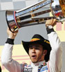 McLaren Formula One driver Lewis Hamilton of Britain holds up his trophy