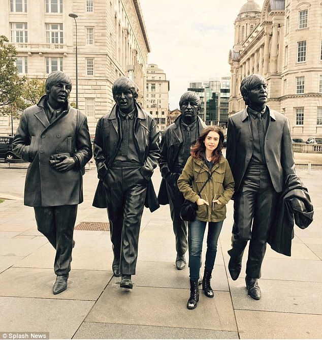 Fab four (plus one): Nicholas stars in the film alongside Lily Collins, 28, who plays his love interest Edith Bratt, the woman Tolkien would eventually marry. She was spotted posing with the Beatles statues in the city