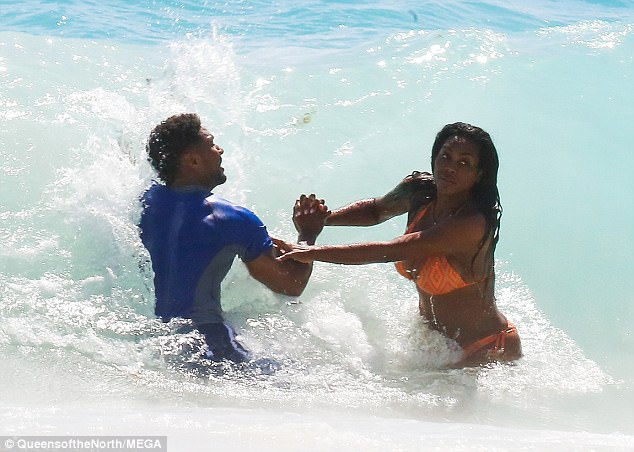 Hold my hand! The Real Housewives Of Atlanta star, 46, slipped into a bright orange bikini as the couple cooled off in the Caribbean sea amid reports they are undergoing fertility treatment