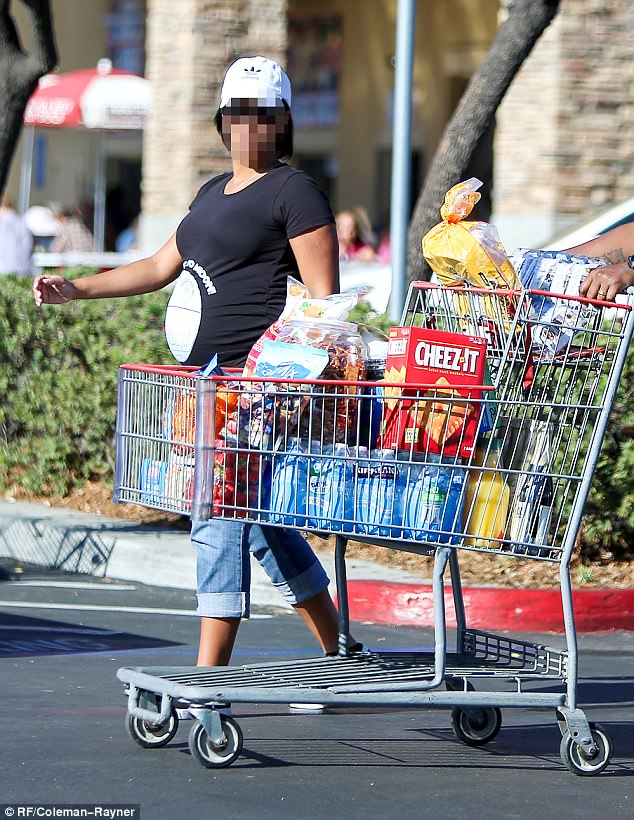 Stocking up! Though her cart was empty, it seems she didn't leave the story empty handed, as she was spotted walking alongside a cart filled to the brim with groceries
