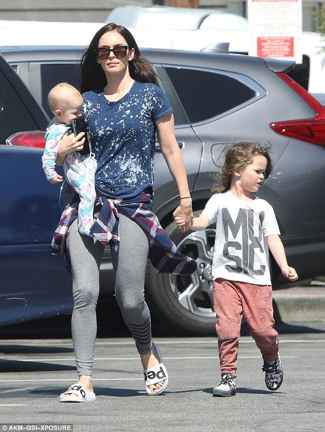 Doting mom: Megan and Brian, 44, are parents to three children together: sons Noah, five; Bodhi, three; and Journey, 16 months; pictured win April 2017