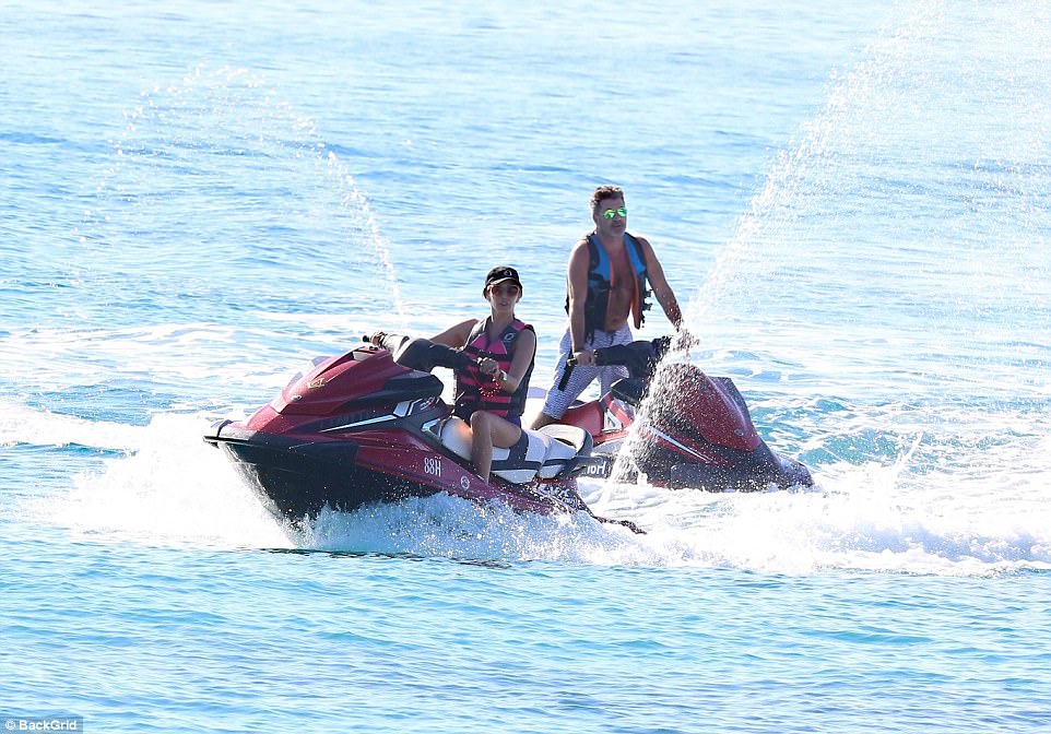 Happy couple: The pair soaked up the sun aboard their jetskis and took in the stunning views