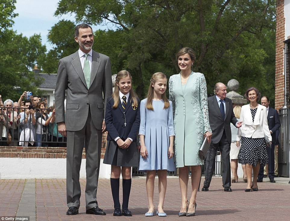 The family-of-four arrived ahead of everyone else and pose for snaps with their daughters 