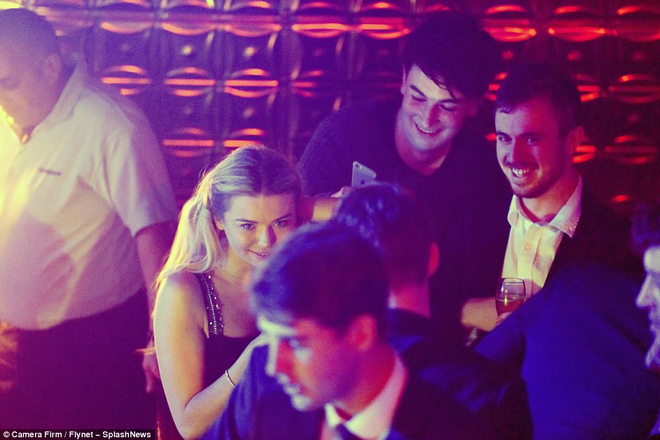 Centre of attention: Toff was surrounded by a large group of friends and male admirers in the club