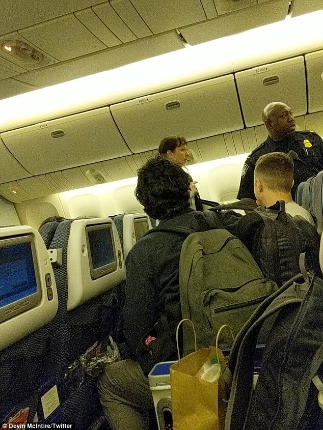 Questioning: Police officers spoke with passengers after the flight landed back at LAX Tuesday evening (above)