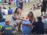 Revellers at the Rhythm and Vines festival in Gisborne, on New Zealand's North Island, watched on as a male attendee (pictured left and right in blue) crept behind and allegedly groped a woman (left and right) wearing only glitter on her breasts