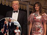 President Donald Trump speaks with reporters as he arrives for a New Year's Eve gala at his Mar-a-Lago resort with  First Lady Melania Trump and their son Barron