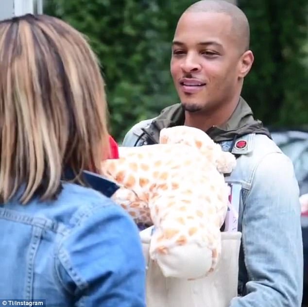 Big heart: Rapper T.I. gave back to his community this Christmas, spreading holiday cheer among some single mothers in an Atlanta-area Target store on Christmas Eve before dropping off presents at a nearby school