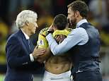 Colombia head coach Jose Pekerman, left, and England head coach Gareth Southgate, right, comfort Colombia's Mateus Uribe after the round of 16 match between Colombia and England