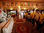 Young footballers rescued from caves in Thailand have started their first day back home by visiting a Buddhist temple - to pay their respects to a diver who died trying to save them