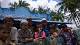 Rohingya children gather outside a mosque at Ah Nauk Pyin