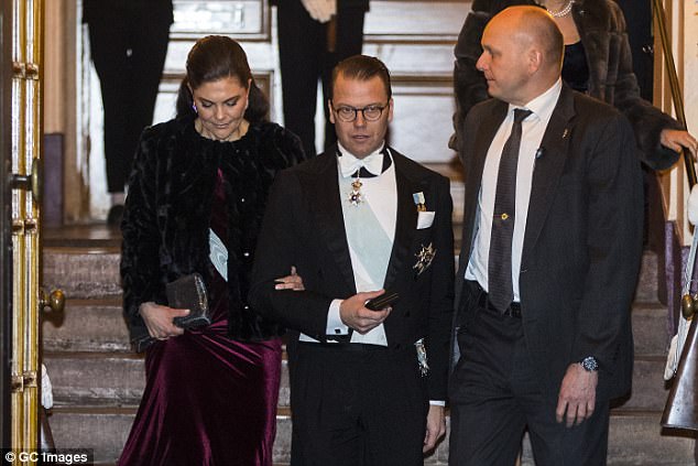 Affectionate Victoria was still holding on to her husband's arm as they left the venue together 