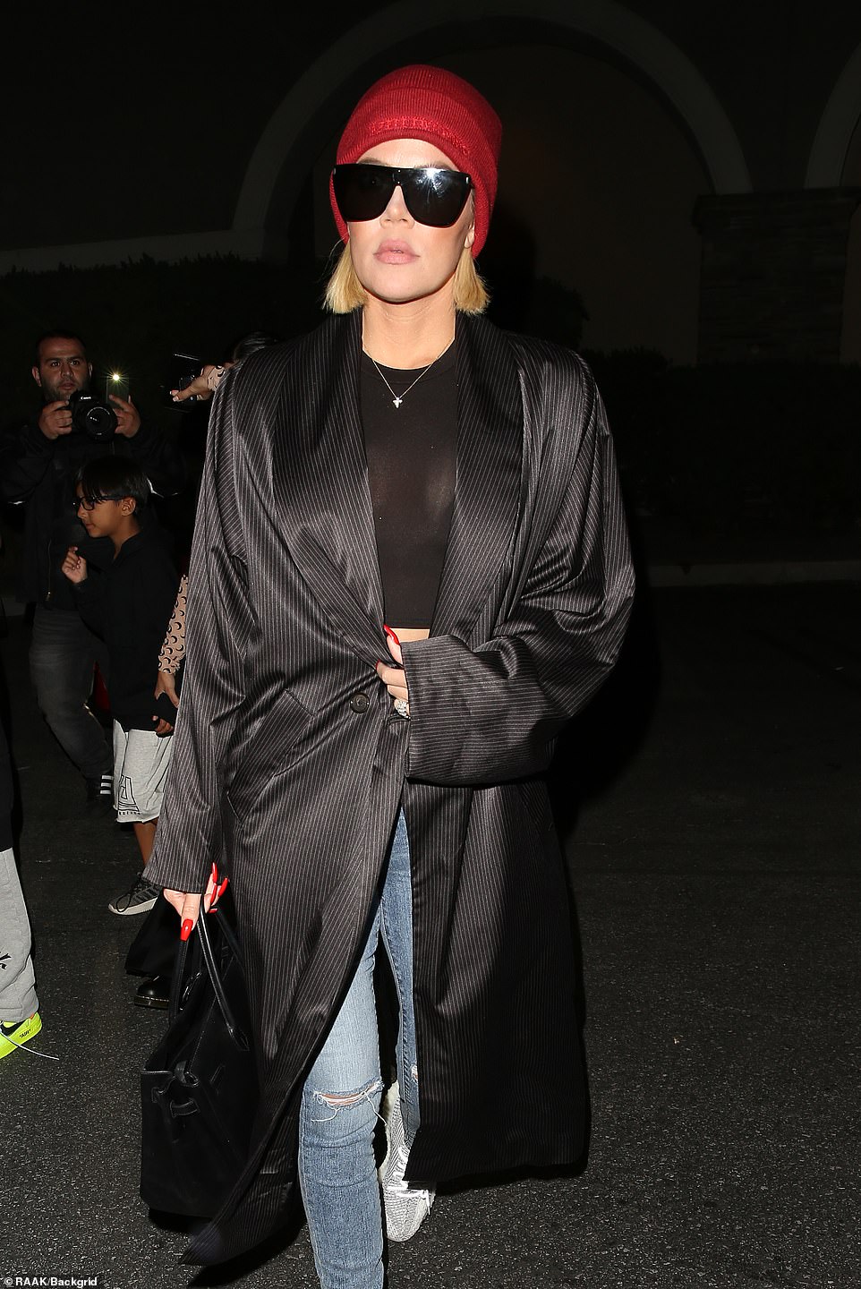 Serious: True to form however, she added in a pair of much-coveted Yeezy trainers alongside a Hermès Birkin bag