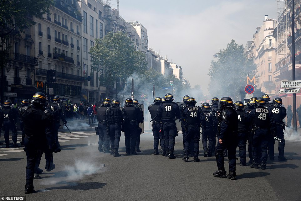 French CRS riot police secure a position during clashes at a demonstration during the traditional May Day labour day in Paris