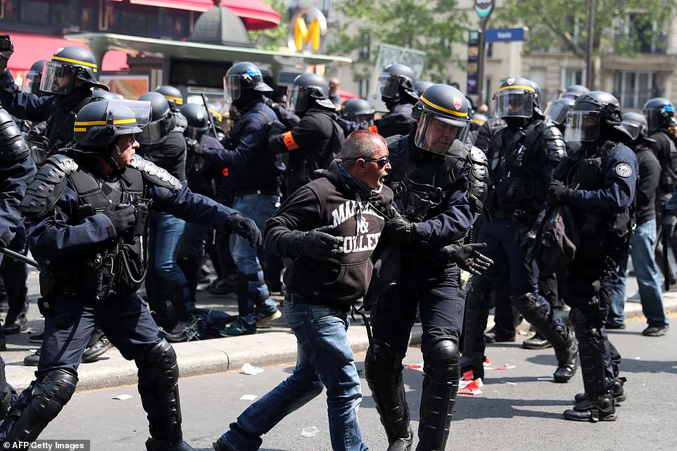 French anti-riot policemen detain a protester in the Montparnasse district of Paris, prior to the start of the annual May Day (Labour Day) workers' demonstration in Paris on May 1