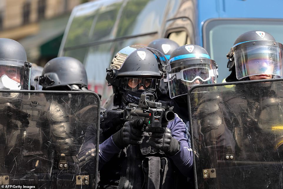 A police officer points a 40-millimetre rubber defensive bullet launcher LBD prior to the start of May Day demonstrations, in Paris on May 1, 2019