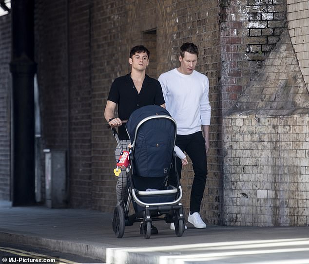 Family: The fathers welcomed their son Robbie last year via a surrogate
