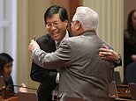 State Sen. Richard Pan, D-Sacramento, left, receives congratulations from Southern California Democratic state Sen. Bob Archuleta, right, after his measure to toughen the rules for vaccination exemptions was approve by the Senate, Wednesday, May 22, 2019, in Sacramento, Calif. The bill, SB276, gives state public health officials instead of local doctors the power to decide which children can skip their shots before attending school. (AP Photo/Rich Pedroncelli)