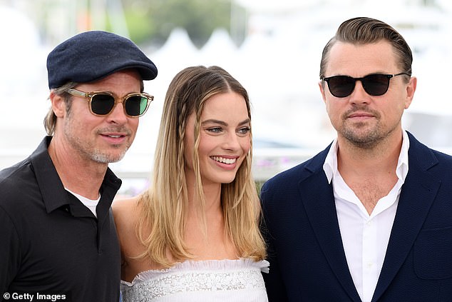 World away: Margot is pictured with co-stars Brad Pitt and Leonardo DiCaprio in Once Upon A Time in Hollywood during the 72nd annual Cannes Film Festival