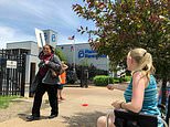 FILE - In this May 17, 2019 file photo, Teresa Pettis, right, greets a passerby outside the Planned Parenthood clinic in St. Louis. Pettis was one of a small number of abortion opponents protesting outside the clinic on the day the Missouri Legislature passed a sweeping measure banning abortions at eight weeks of pregnancy. Planned Parenthood says Missouri's only abortion clinic could be closed by the end of the week because the state is threatening to not renew its license, which expires Friday, May 31. (AP Photo/Jim Salter, File)