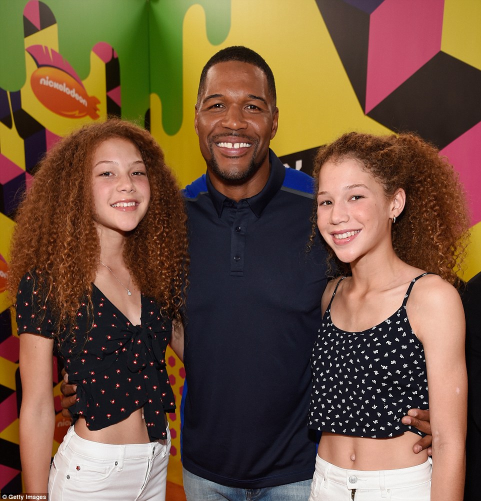 Doting dad: Former New York Giants defensive end Michael Strahan, 46, poses with his daughters Isabella, 13, and Sophia, 13