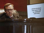 Judge Thad Balkman listens during opening arguments for the state of Oklahoma Tuesday, May 28, 2019, in Norman, Okla., as the nation's first state trial against drugmakers blamed for contributing to the opioid crisis begins in Oklahoma. At right is a slide from the state's presentation shown on a monitor. (AP Photo/Sue Ogrocki)