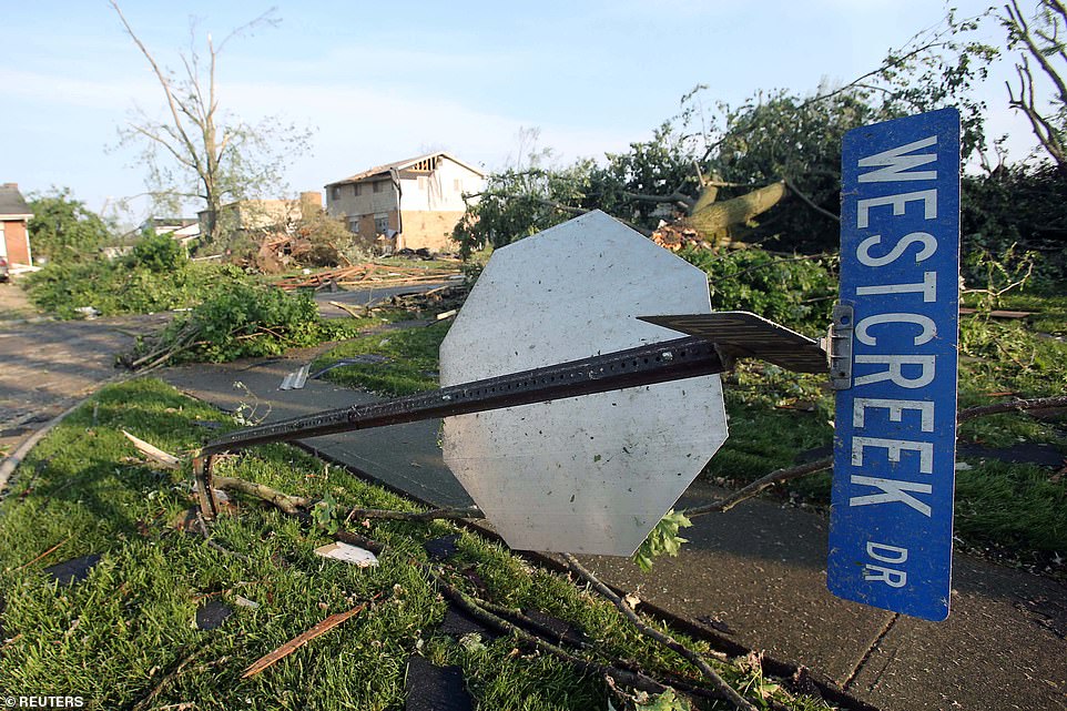 A Trotwood street sign was bent in the tornado, which brought down trees and power lines and scattered debris across the city