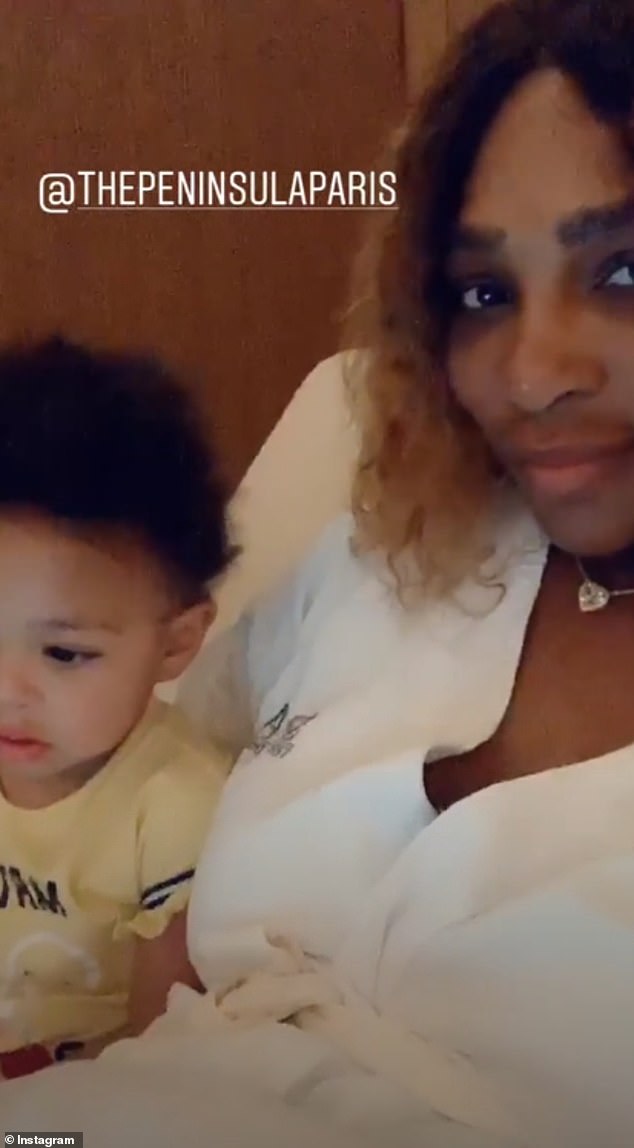 Family fun: Their daughter Olympia was in the room, and mom kept her occupied with videos