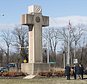 FILE - In this Feb. 13, 2019 file photo, visitors walk around the 40-foot Maryland Peace Cross dedicated to World War I soldiers in Bladensburg, Md. The Supreme Court says the World War I memorial in the shape of a 40-foot-tall cross can continue to stand on public land in Maryland. The high court on Thursday rejected a challenge to the nearly 100-year-old memorial. The justices ruled that its presence on public land doesn't violate the First Amendment's establishment clause. That clause prohibits the government from favoring one religion over others.(AP Photo/Kevin Wolf)