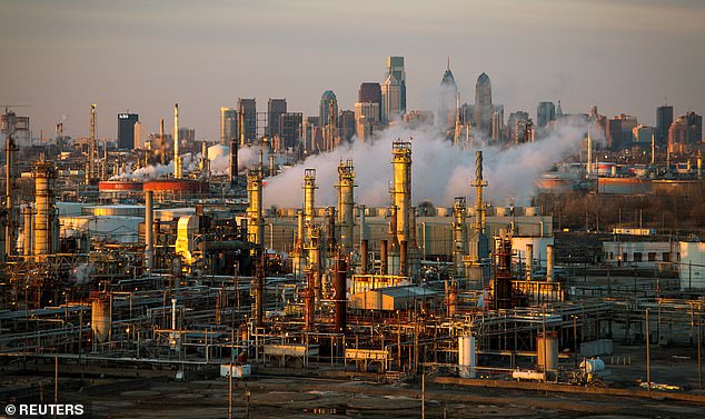 The Philadelphia Energy Solutions oil refinery owned by The Carlyle Group is seen at sunset in front of the Philadelphia skyline (file image from March 2014)