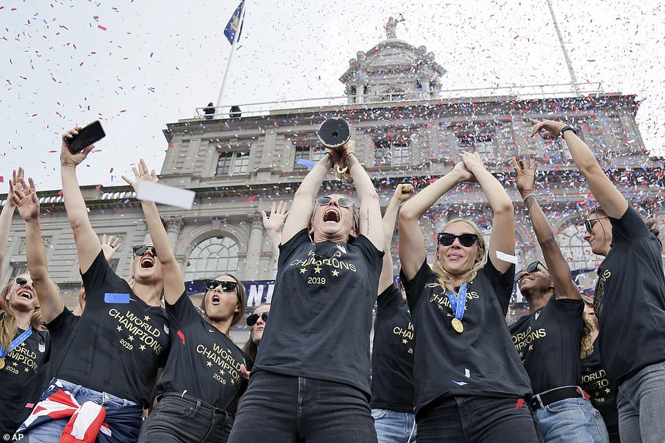 Megan Rapinoe and her U.S. women's soccer teammates raise the World Cup trophy at New York's City Hall