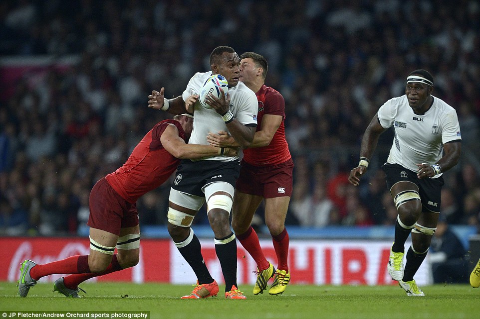 Tackle: Akapusi Qera, the Fiji captain, is tackled by Tom Wood of England and Brad Barritt of England (behind) during tonight's match
