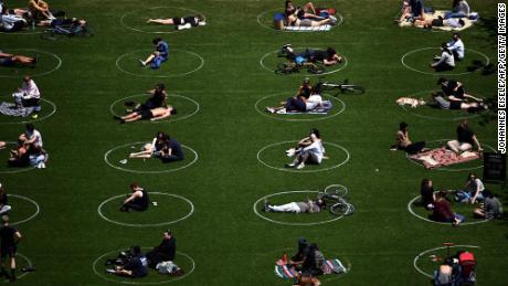 TOPSHOT - People are seen practising social distancing in white circles in Domino Park, during the Covid-19 pandemic on May 17, 2020 the in Brooklyn borough of New York City. (Photo by Johannes EISELE / AFP) (Photo by JOHANNES EISELE/AFP via Getty Images)
