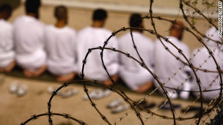File photo: A group of detainees kneels during an early morning Islamic prayer in their camp at the US military prison for &#39;enemy combatants&#39; on October 28, 2009, in Guantanamo Bay, Cuba. 