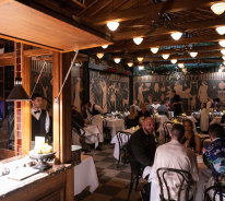 The main 50-seat dining room is lined with an Etruscan mural, giving it the air of a basement crypt.