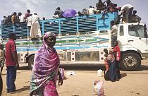 People board a truck as they leave Khartoum, Sudan, on June 19, 2023