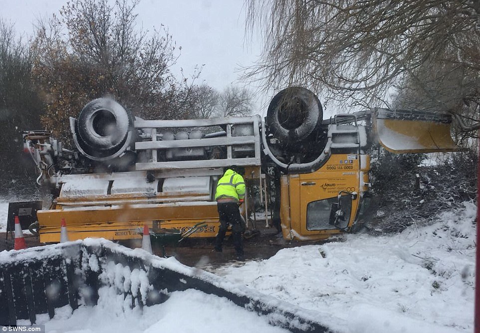 These shocking photos show the moment a gritter overturned on an icy road and landed on its roof. It happened amid heavy snowfall, thought to be four inches deep, in Tamworth, Staffs, today