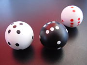 Spherical dice. Inside weights make the numbers face up.
