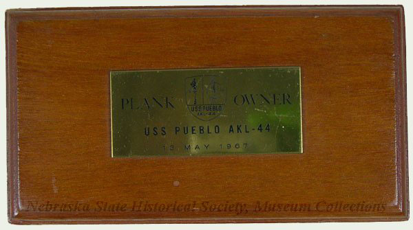 Plank Owner plaque. A plank owner is a member of a ship’s crew when it is first placed into commission or sometimes, re-commissioned.