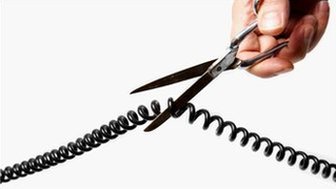 A telephone cord is cut with scissors