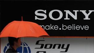 Man walks past Sony logo