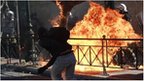 A protester throws a petrol bomb at police during a rally on the first day of a 48-hour general strike in Athens October 19