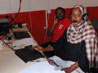 Data Officer Rahab Mburunga and Warehouse Tally Clerk Rahima Abdikadir at work recording messages in Kiswahili for the telephone information lines at the ActionAid communications hub in Isiolo, Northern Kenya. Photo: Robert Powell.