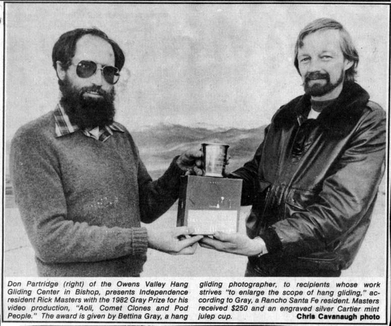 Don Partridge (right) of the Owens Valley Hang Gliding Center in Bishop, presents Independence resident Rick Masters with the 1982 Gray Prize for his video production, "Aoli, Comet Clones and Pod People." The award is given by Bettina Gray, a hang gliding photographer, to recipients whose work strives "to enlarge the scope of hang gliding," according to Gray, a Rancho Santa Fe resident.  Masters received $250 and an engraved Cartier mint julep cup.  Chris Cavenaugh photo