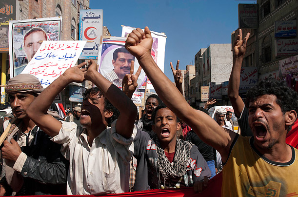 Anti-government protesters shout slogans during a march to demand the ouster of the whole regime of Yemen's outgoing President Ali Abdullah Saleh in the southern city of Taiz,