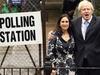 Boris Johnson, the current mayor of London, standing in front of a polling station with his wife.