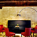 The red and black leather seating in the dining area was custom-made by Architema. The Castiglioni Arco lamp ($2,232) and the Le Corbusier table ($4,960) were bought at auction in Milan.